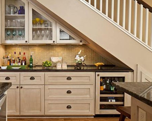 Example of home renovation that cleverly used waisted space under the stairs transformed into a functional kitchen