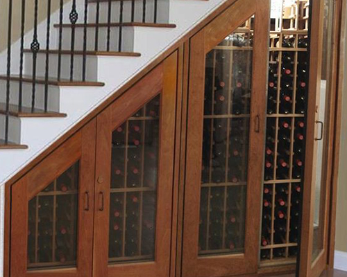 wine cabinet that was created from the wasted space of the stairs 