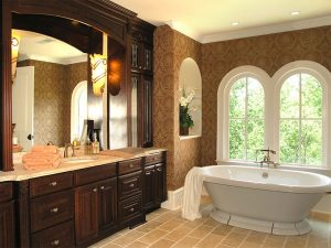 A custom bathroom design with a distinctive masculine feel, with dark cabinetry and free standing tub.