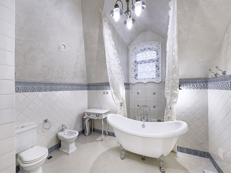 Vintage style bath with clawfoot tub for custom luxury bathrooms.