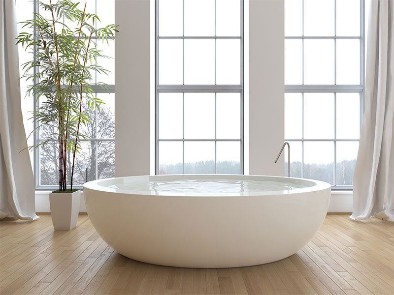 Large freeform freestanding tub with a zen feel for custom luxury bathrooms.